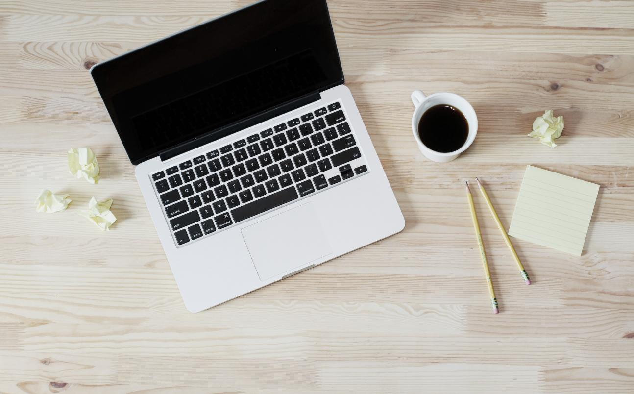 laptop and coffee on wooden desk