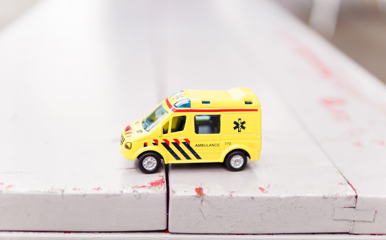 Yellow toy ambulance on table