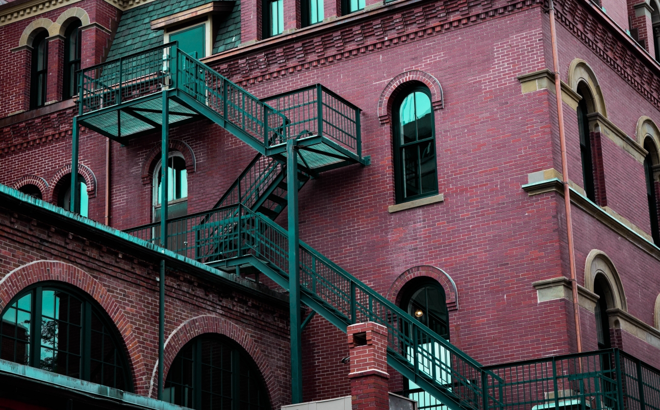 Red building with external stairs going up